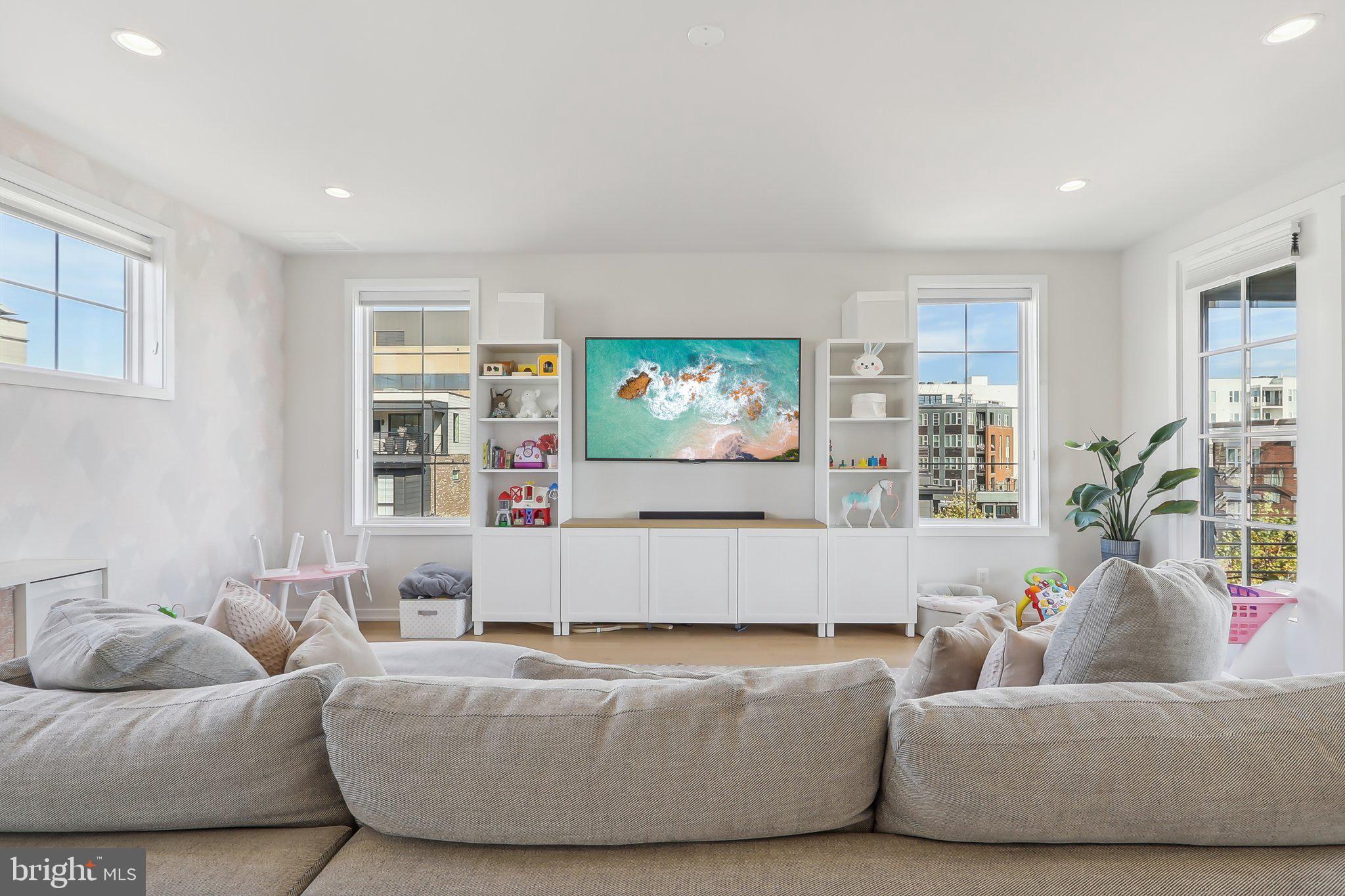 1970 Roland Clarke Place Reston, VA 20191 - Photo 54 of 72 a living room with furniture and a flat screen tv