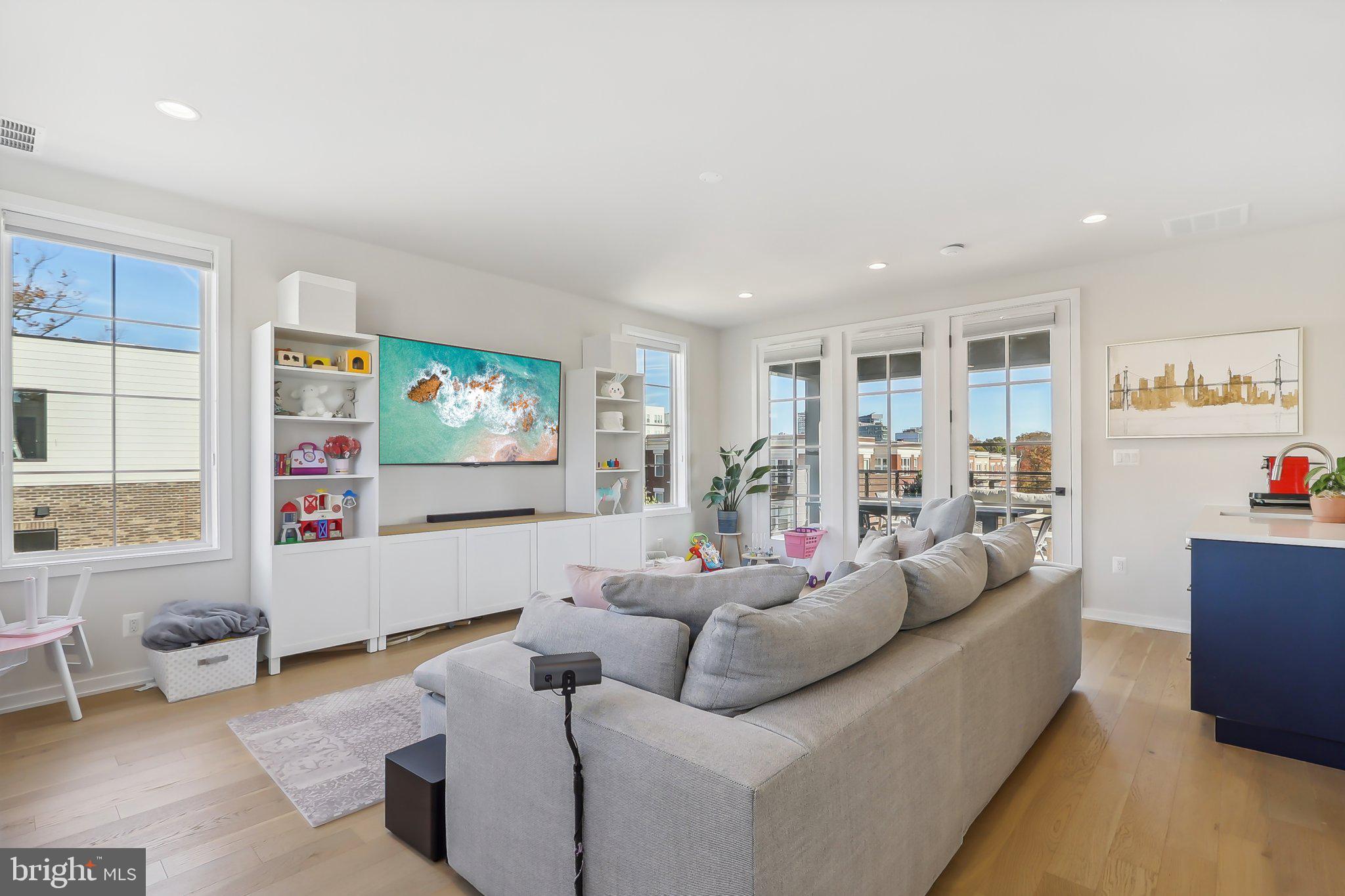 1970 Roland Clarke Place Reston, VA 20191 - Photo 55 of 72 a living room with furniture and a flat screen tv