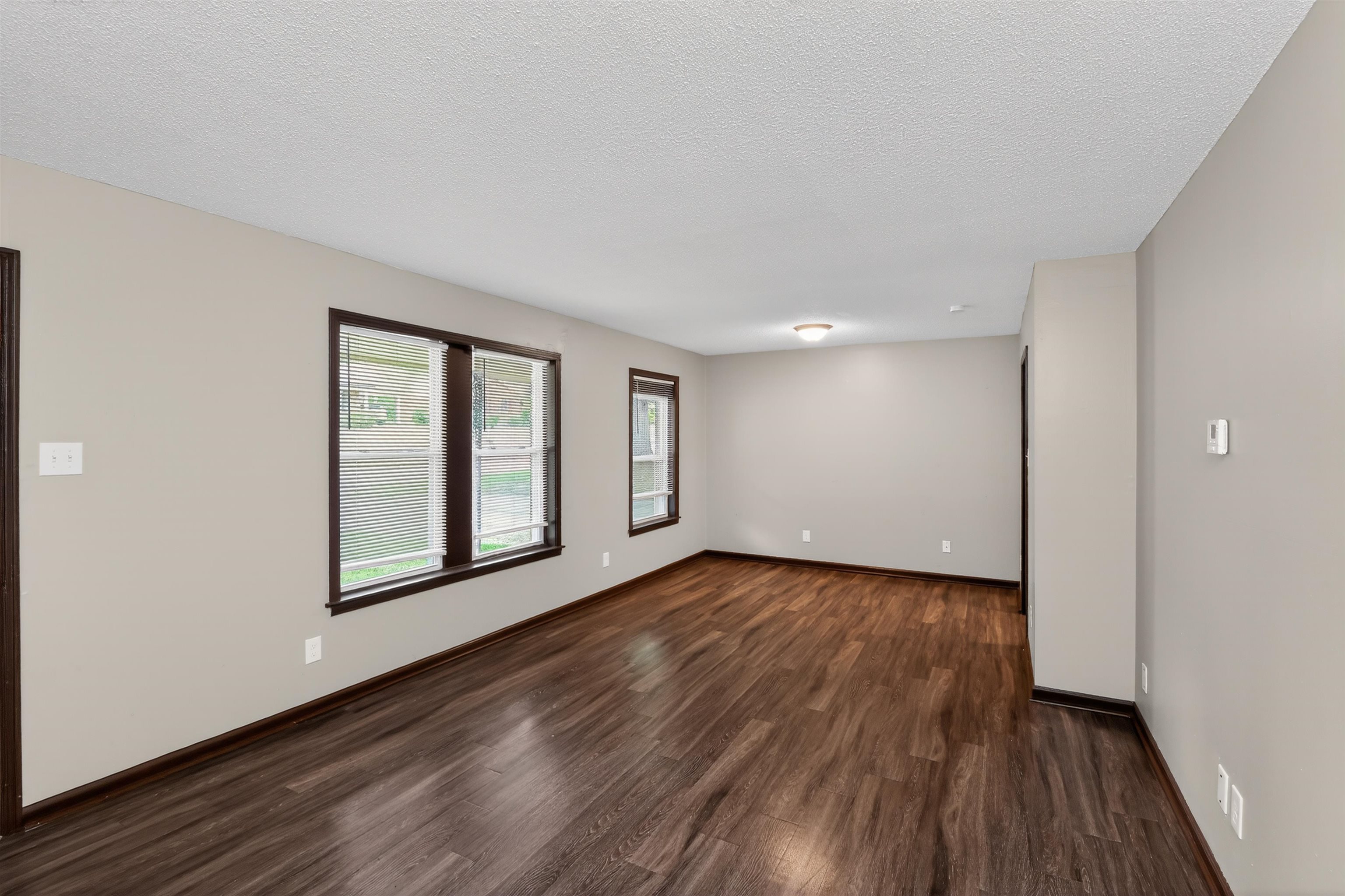 4206 Riche Road Memphis, TN 38128 - Photo 8 of 30 Spacious interior room featuring wood-finish flooring, neutral wall tones, and dark trim details