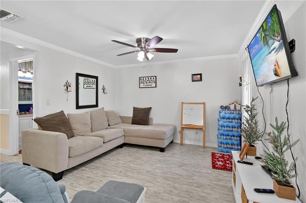 5 Pinewood Boulevard Lehigh Acres, FL 33936 - Photo 12 of 26 a living room with furniture and a potted plant