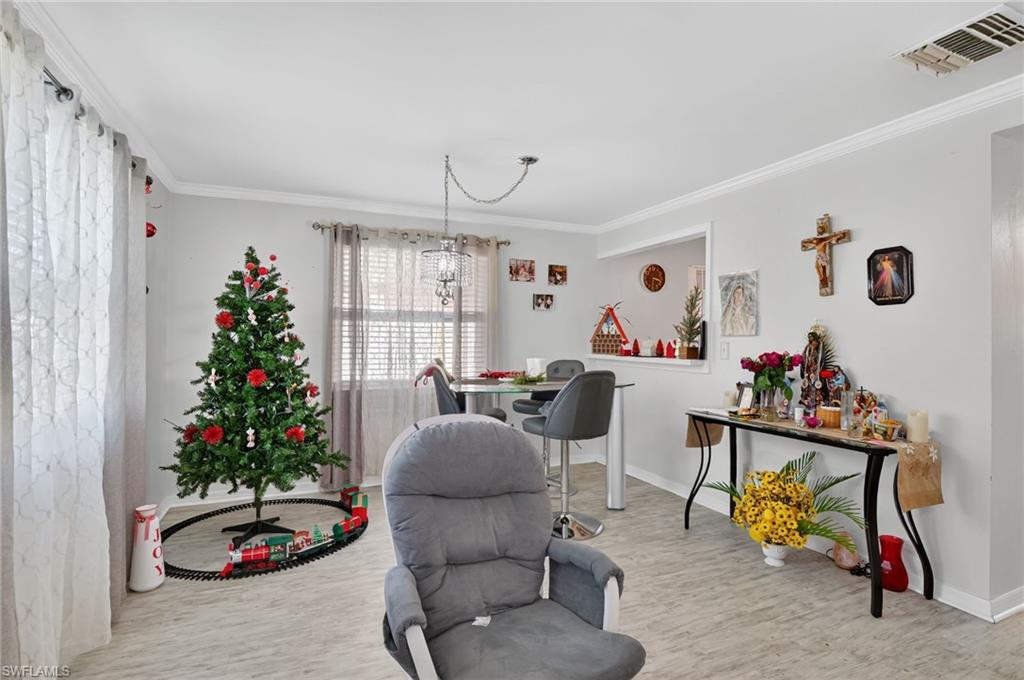 5 Pinewood Boulevard Lehigh Acres, FL 33936 - Photo 14 of 26 a living room with furniture and a potted plant