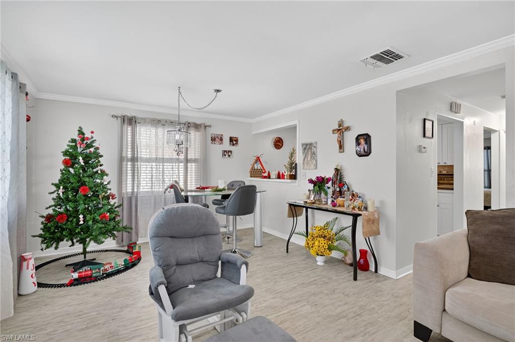 5 Pinewood Boulevard Lehigh Acres, FL 33936 - Photo 15 of 26 a living room with furniture and flowers