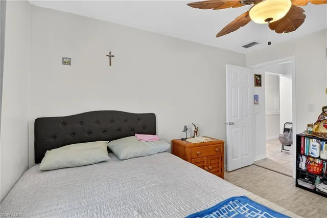 a bedroom with a bed and painting on the wall