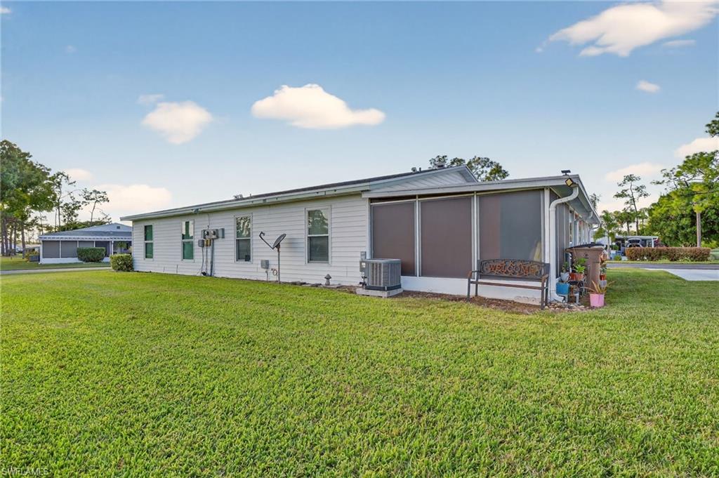 5 Pinewood Boulevard Lehigh Acres, FL 33936 - Photo 25 of 26 a view of a house with a backyard