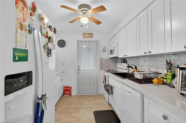 a kitchen with a refrigerator a sink and cabinets