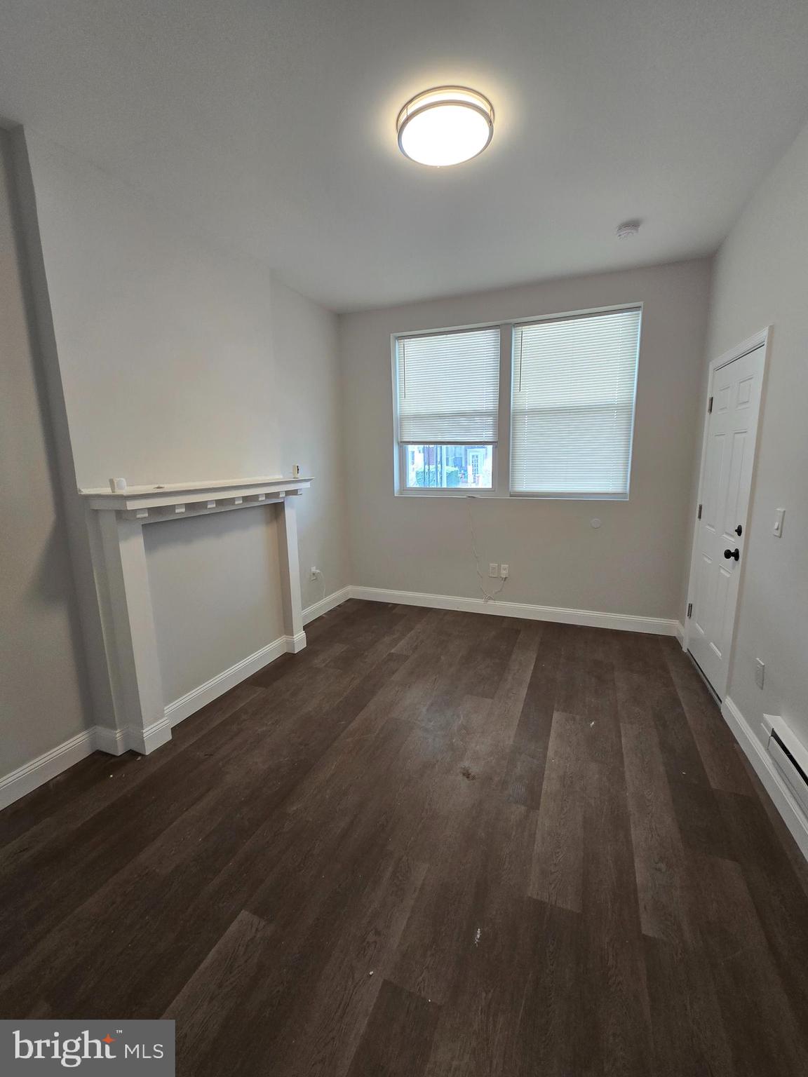 4645 North 13th Street, Unit 1 Philadelphia, PA 19140 - Photo 4 of 16 an empty room with wooden floor and windows
