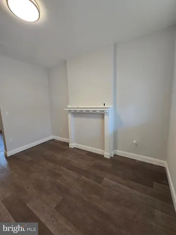 a view of an empty room and wooden floor