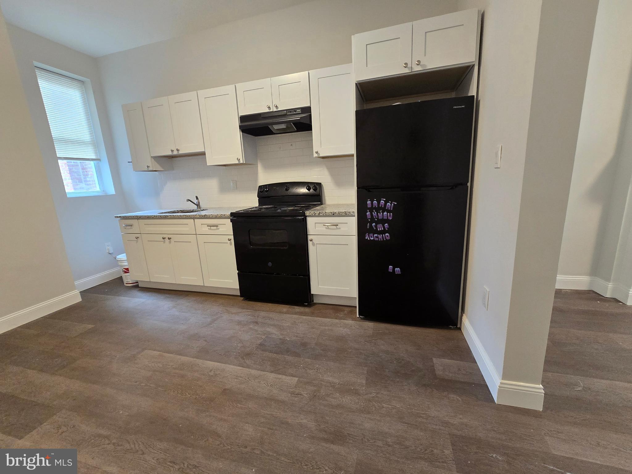 4645 North 13th Street, Unit 1 Philadelphia, PA 19140 - Photo 7 of 16 a kitchen with a refrigerator and a stove