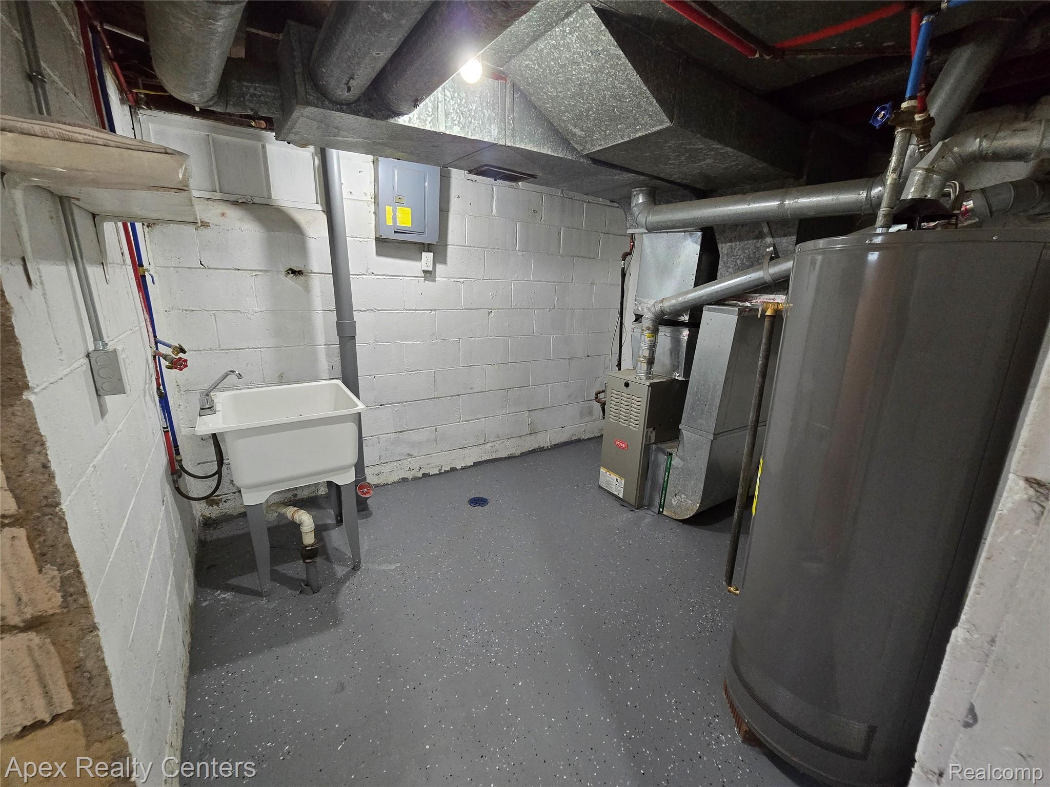 7671-7675 Evergreen Road Detroit, MI 48228 - Photo 52 of 84 7671 Evergreen. Utility room featuring a laundry sink with faucet, water heater, furnace, and exposed ductwork