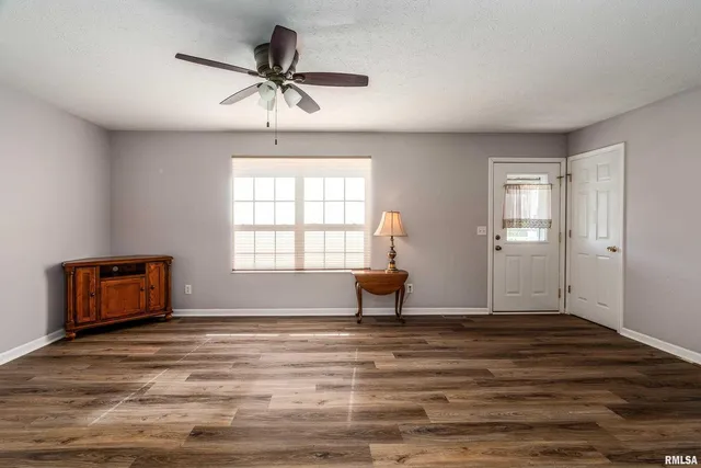 a bedroom with furniture window and wooden floor