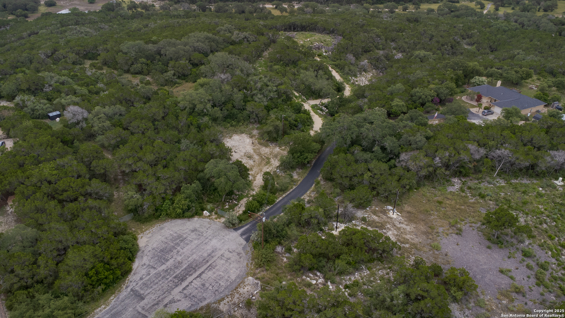 199 County Road 2733 Mico, TX 78056 - Photo 2 of 19 an aerial view of residential house with outdoor space and trees all around