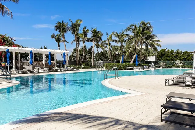 a view of a swimming pool with an outdoor space and seating area