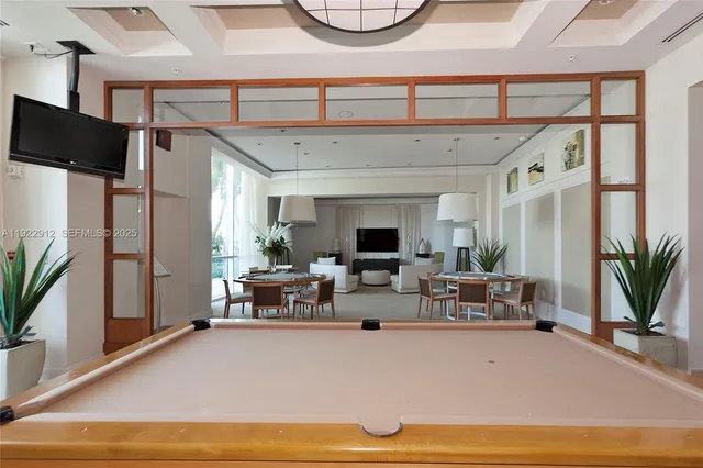 a living room with furniture a large window and a flat screen tv