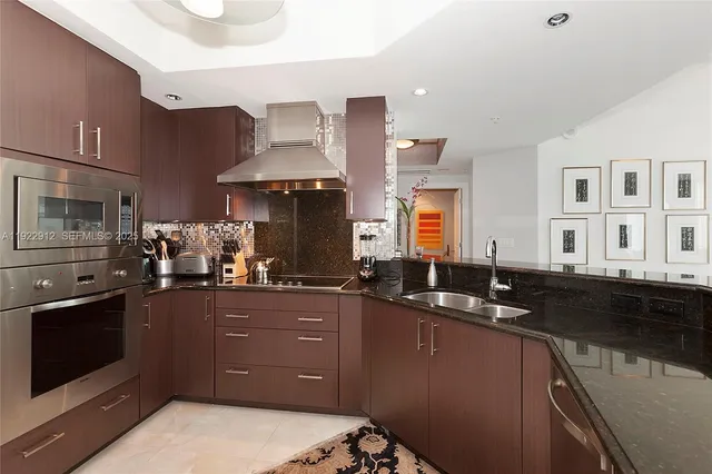 a kitchen with granite countertop a sink and cabinets