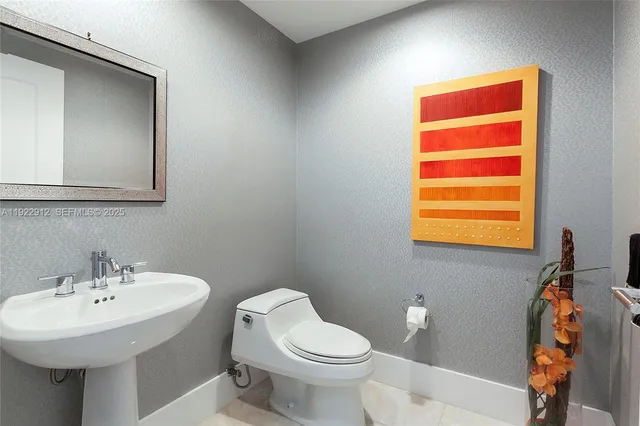 a bathroom with a sink a mirror and a toilet