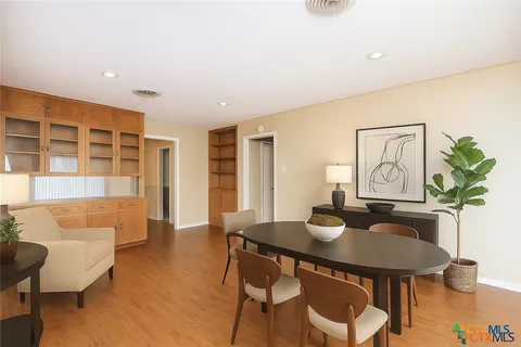 a dining room with furniture and wooden floor