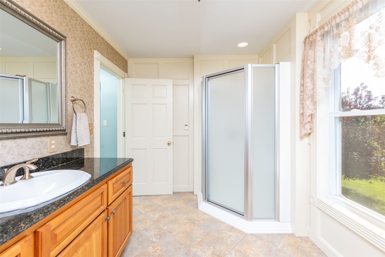 227 Baynes Road Waynesboro, VA 22980 - Photo 31 of 49 a bathroom with a granite countertop sink mirror and a bathtub