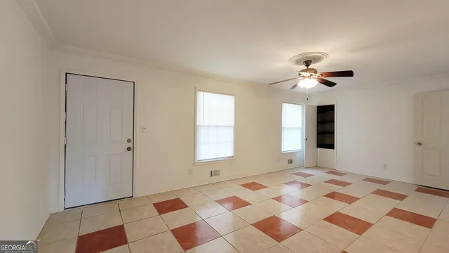 a view of a bedroom with wooden floor and a window