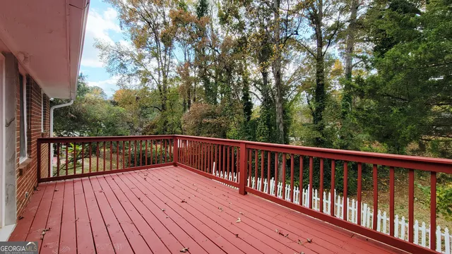 a view of balcony with wooden floor and fence