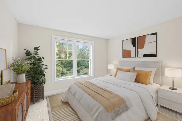 a bedroom with a large bed and a potted plant