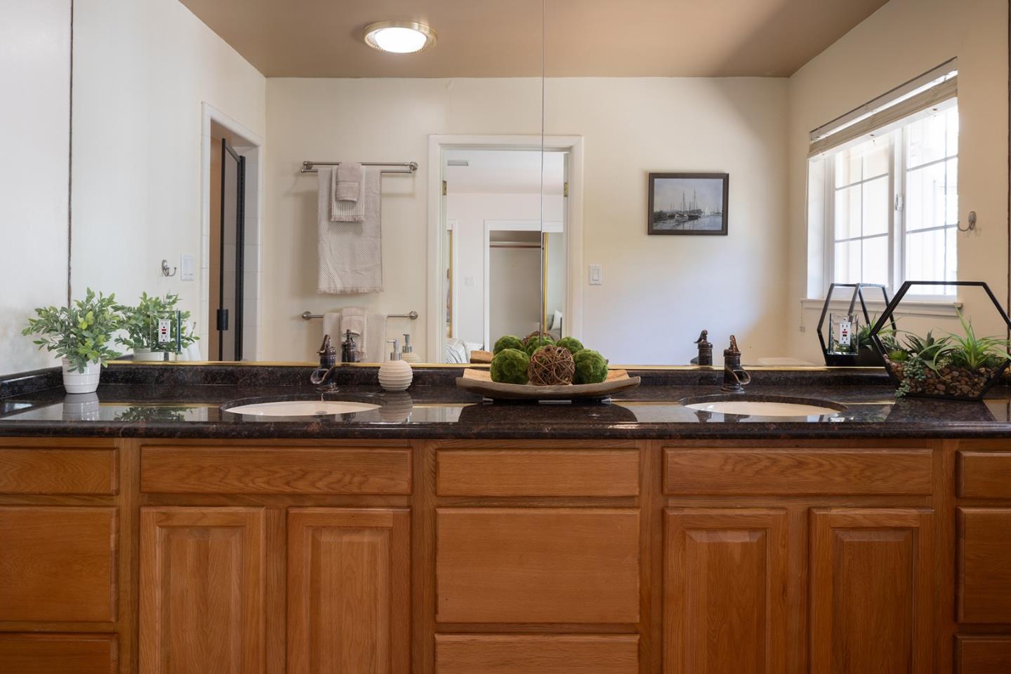 3050 Ribera Road Carmel, CA 93923 - Photo 18 of 27 a bathroom with a granite countertop sink mirror and cabinets