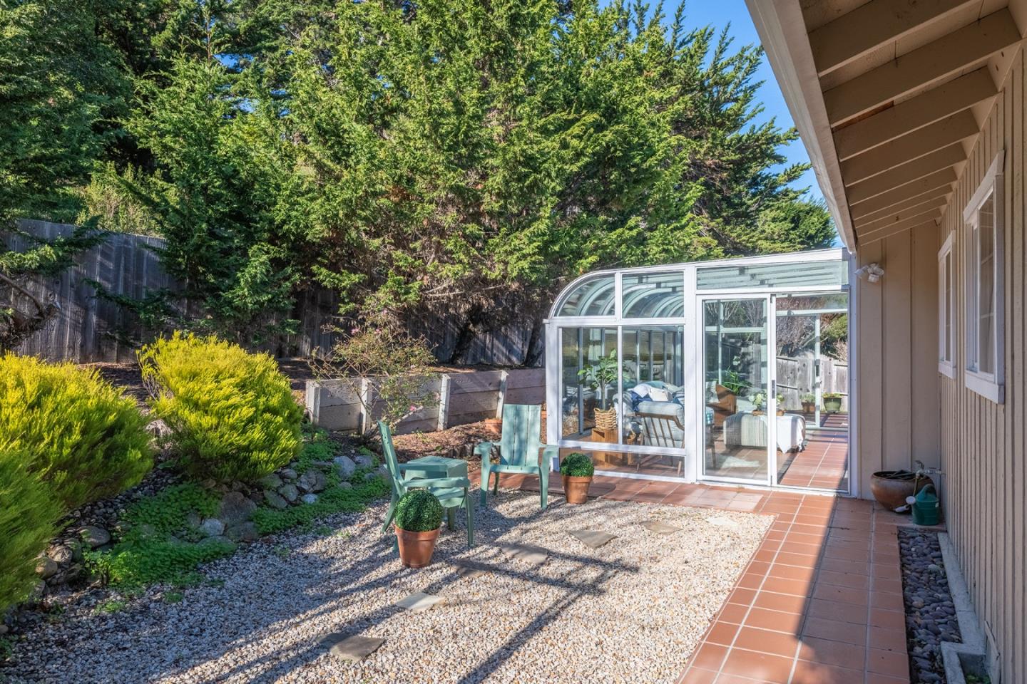 3050 Ribera Road Carmel, CA 93923 - Photo 23 of 27 a view of a house with backyard sitting area and garden