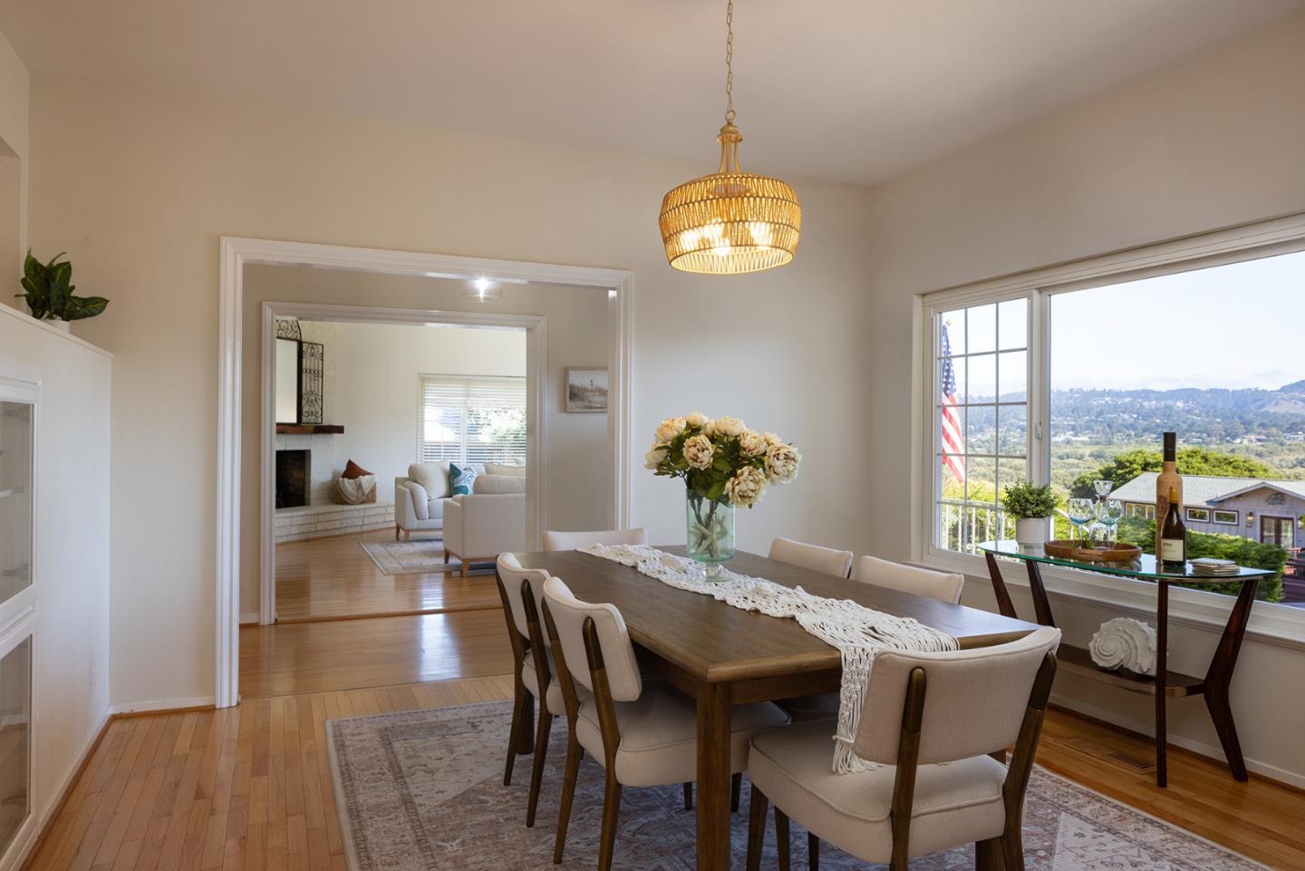 3050 Ribera Road Carmel, CA 93923 - Photo 9 of 27 a view of a dining room with furniture a chandelier and wooden floor