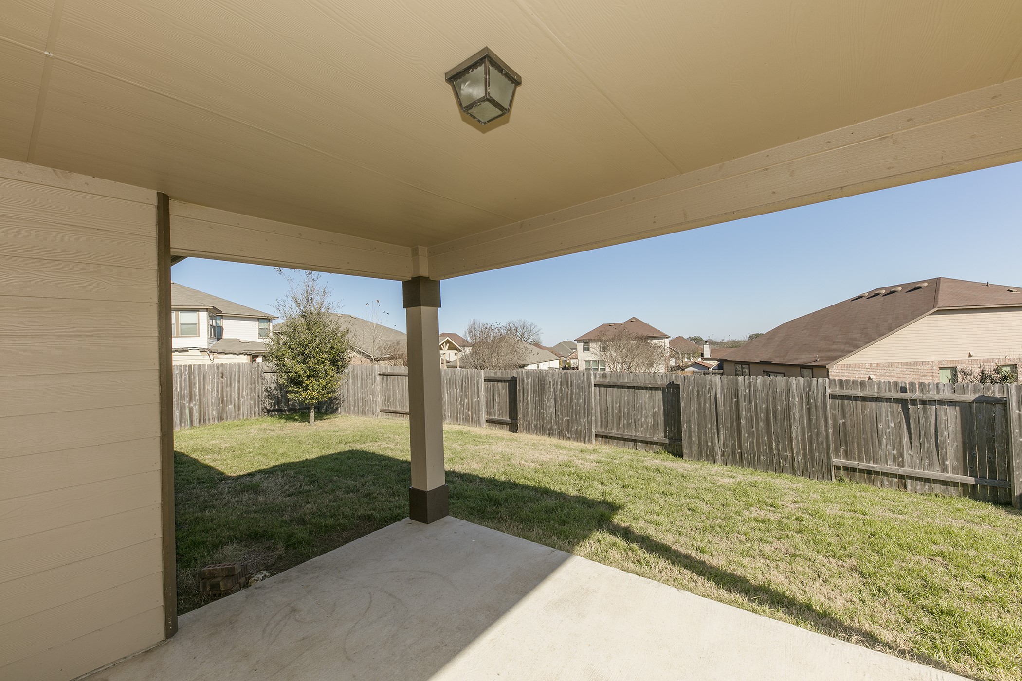 1141 Renaissance Trail Round Rock, TX 78665 - Photo 15 of 23 A spacious, enclosed yard features a covered patio, perfect for outdoor relaxation.