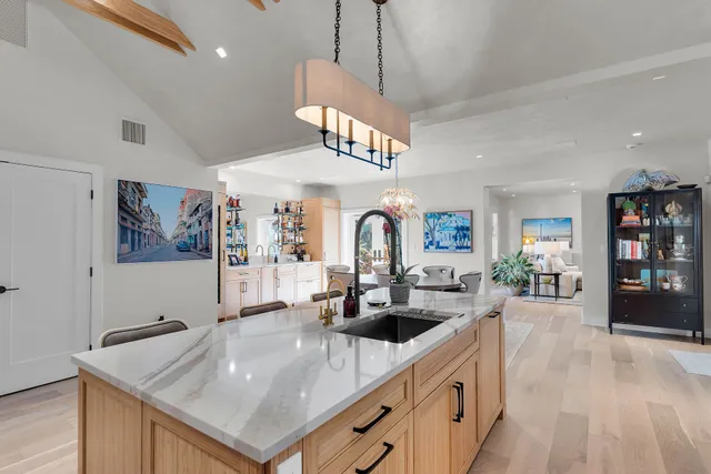 a kitchen that has cabinets a sink and dishwasher