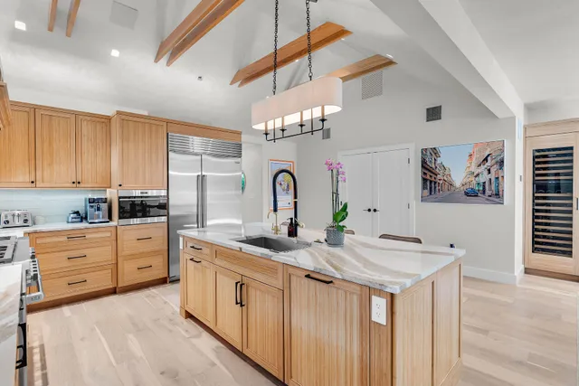 a living room with patio furniture and a floor to ceiling window
