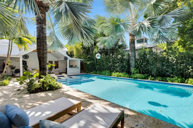 a bathroom with a double vanity sink mirror and shower