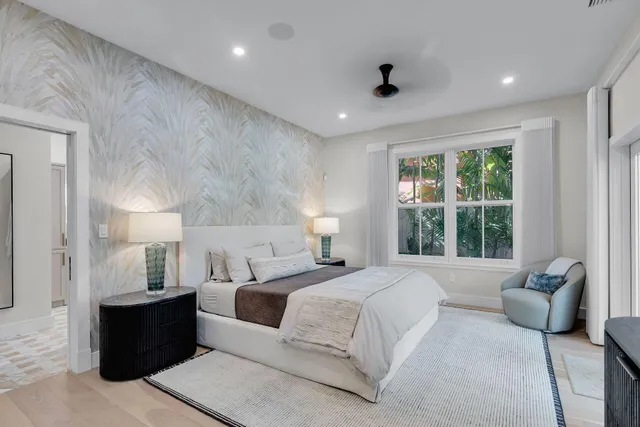 a spacious bedroom with a large bed and windows