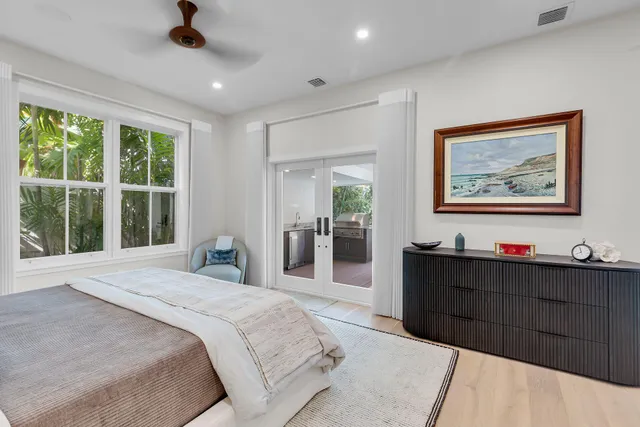 a bedroom with a large bed and a chandelier