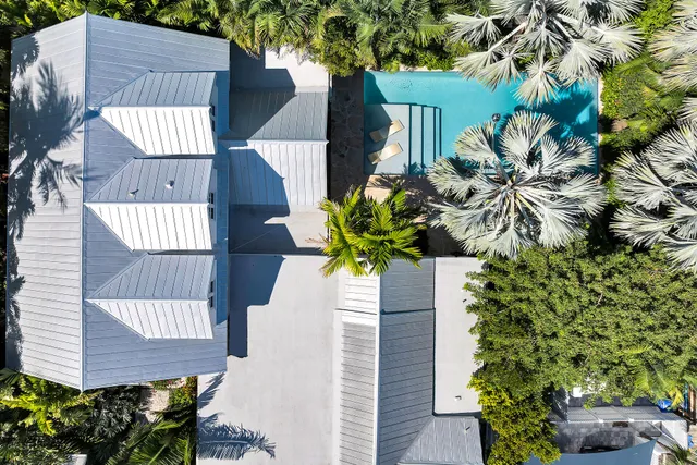 a vase of flowers sitting on a wooden floor