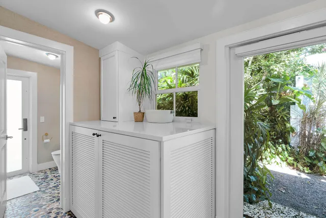 a white toilet sitting next to a window