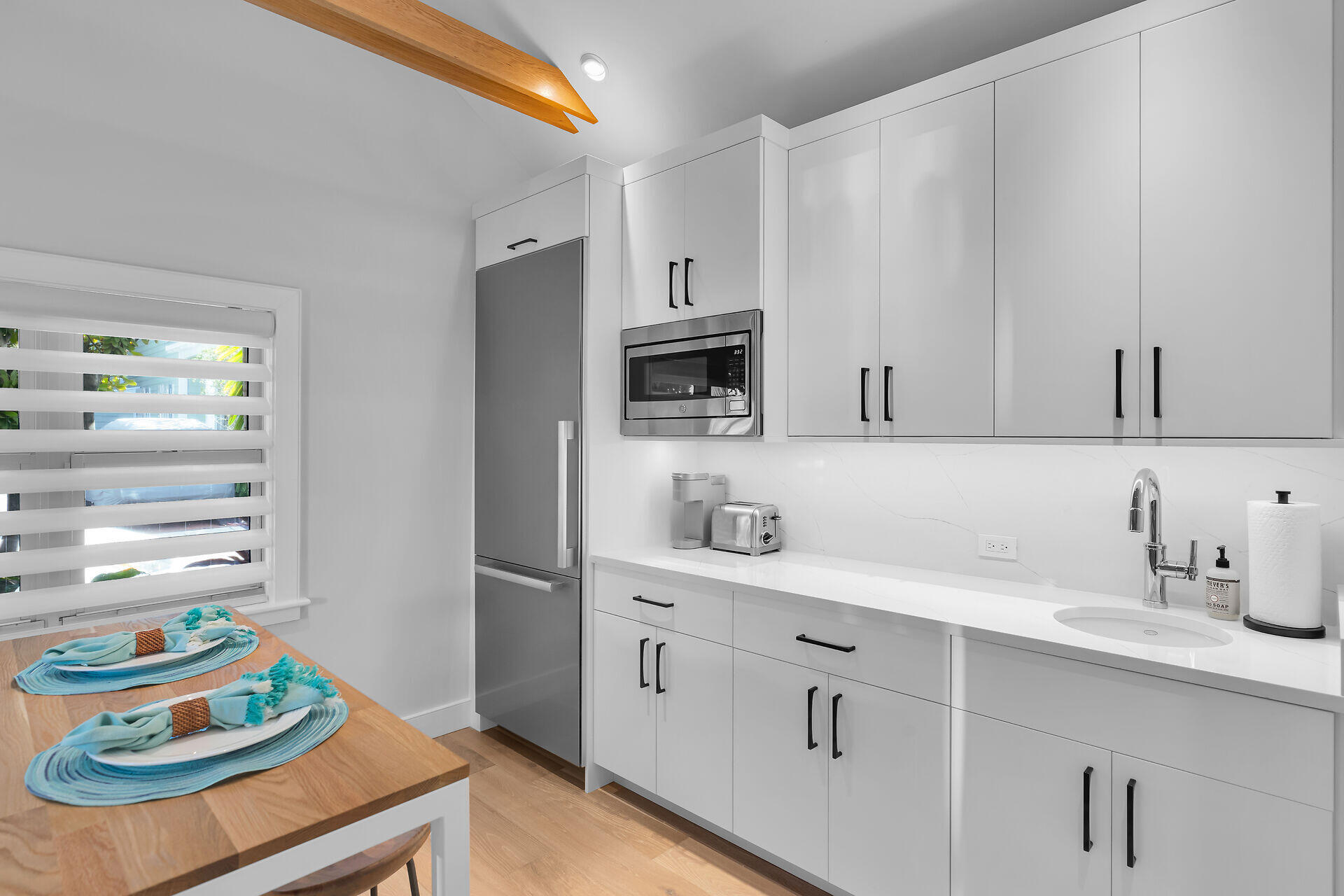 411 Louisa Street Key West, FL 33040 - Photo 49 of 71 a kitchen with stainless steel appliances a sink a stove and cabinets