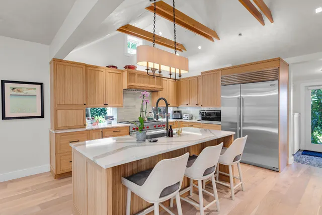 a kitchen with stainless steel appliances granite countertop a sink and a stove
