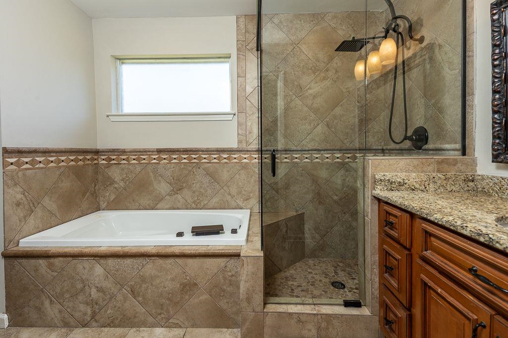 9768 Riggin Drive Memphis, TN 38002 - Photo 18 of 32 Tiled soaking tub and walk-in shower with glass enclosure