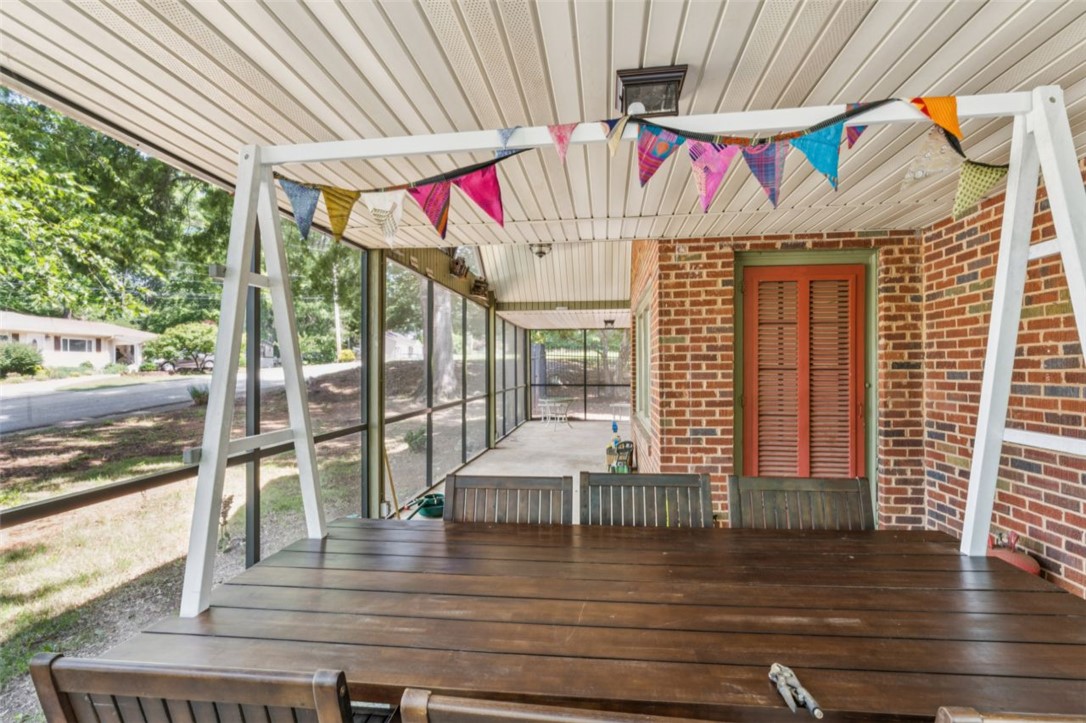 321 South Pine Street Walhalla, SC 29691 - Photo 14 of 32 Enjoy outdoor living on this expansive screened porch, featuring a durable concrete floor and brick exterior.