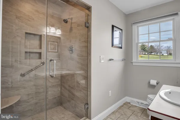 a bathroom with a sink toilet and a mirror