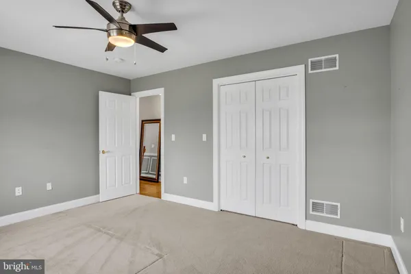 a view of a livingroom with a ceiling fan and window