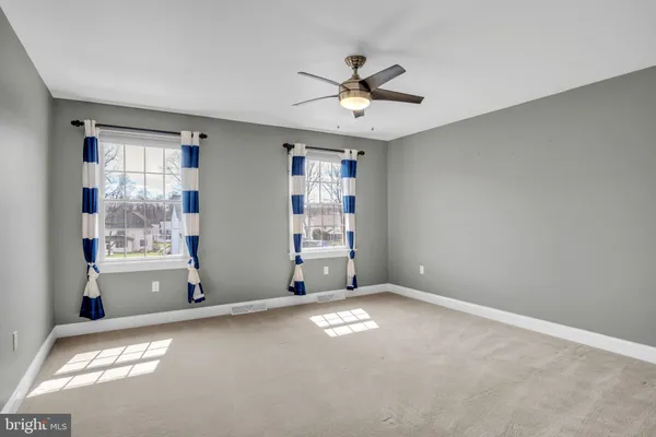a bathroom with a granite countertop sink a toilet a mirror and shower