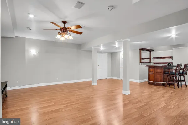 a view of a room with furniture and wooden floor