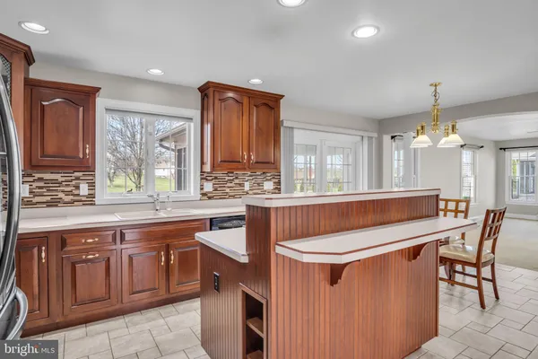 a kitchen with stainless steel appliances granite countertop a sink and a refrigerator