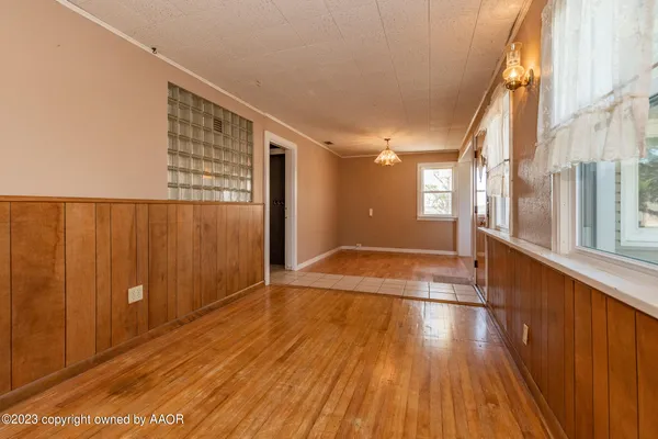a kitchen with stainless steel appliances granite countertop a stove a refrigerator and a sink with wooden cabinets