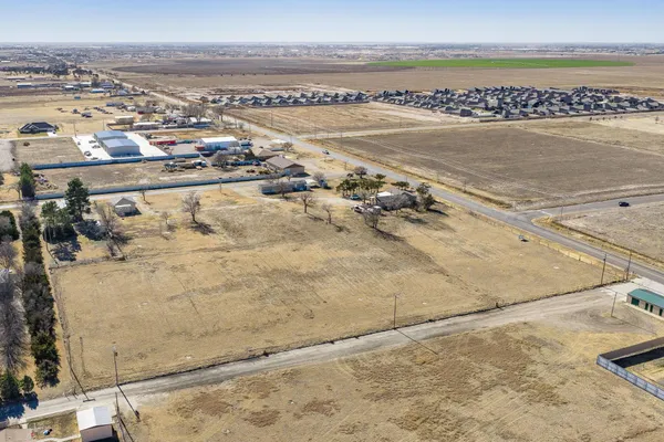 a view of a livingroom with a chandelier fan and wooden floor