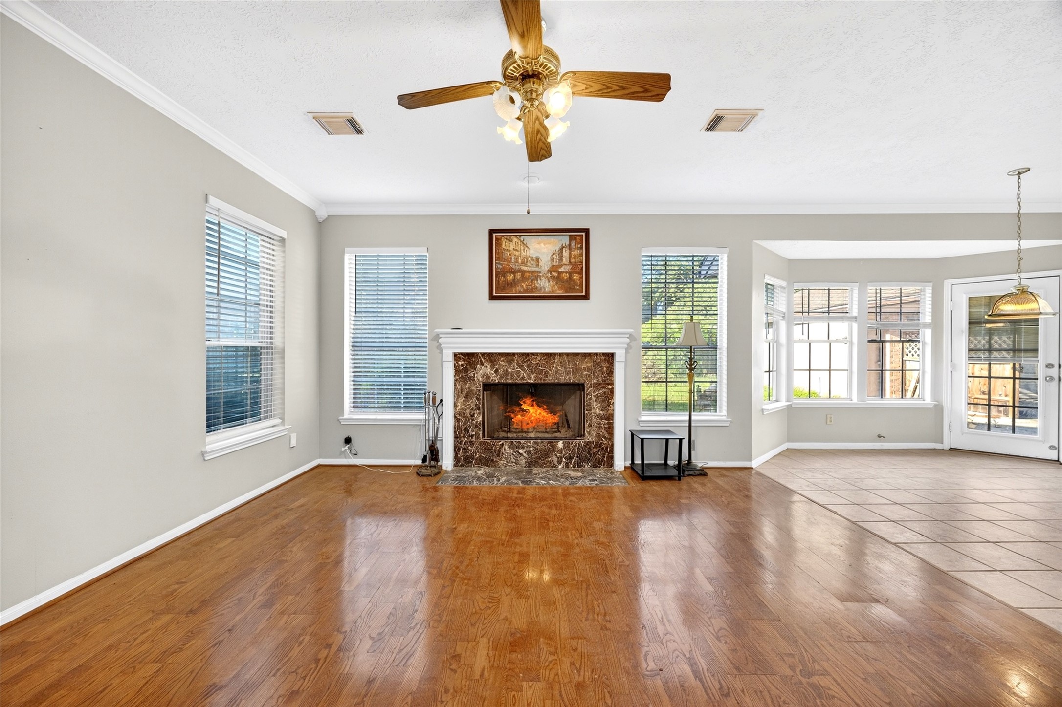10615 Vandercroft Court Houston, TX 77070 - Photo 15 of 47 a view of a livingroom with a fireplace a ceiling fan and windows