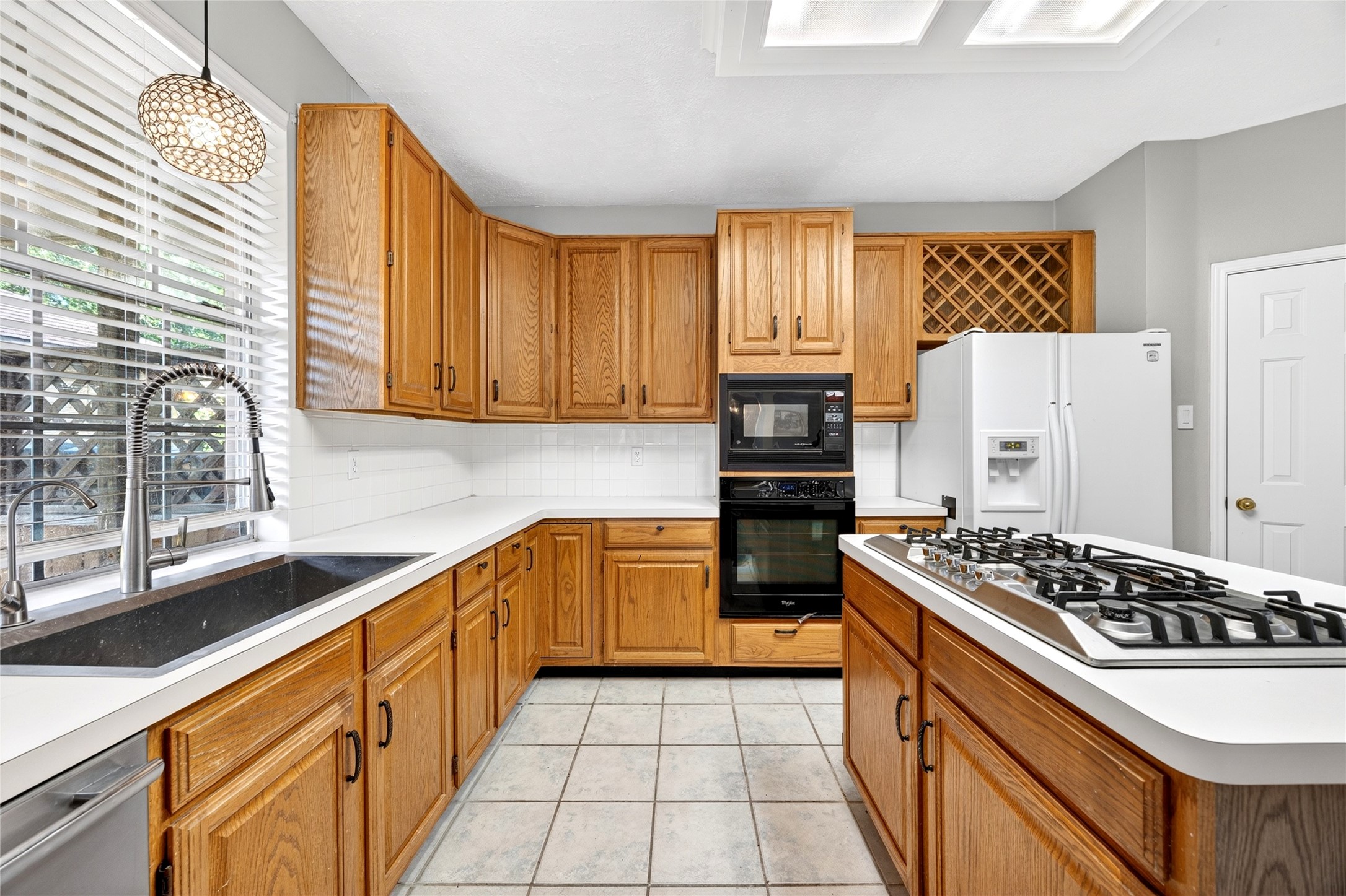 10615 Vandercroft Court Houston, TX 77070 - Photo 21 of 47 a kitchen with stainless steel appliances a stove a sink and a refrigerator