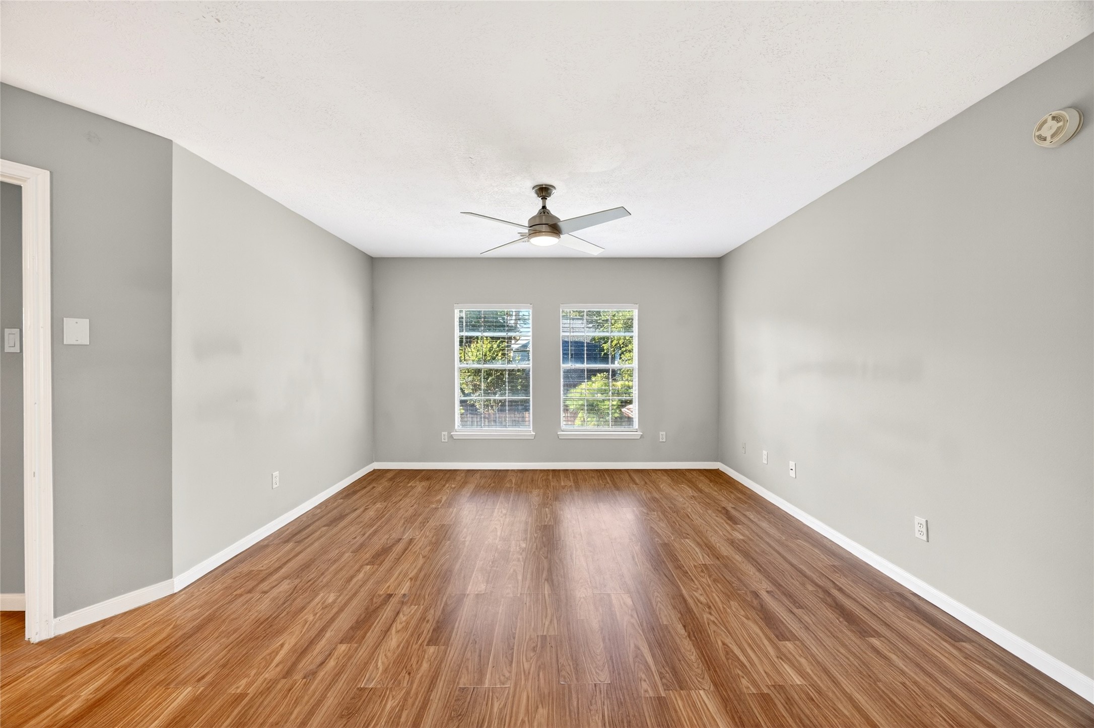 10615 Vandercroft Court Houston, TX 77070 - Photo 26 of 47 a view of an empty room with wooden floor and a window