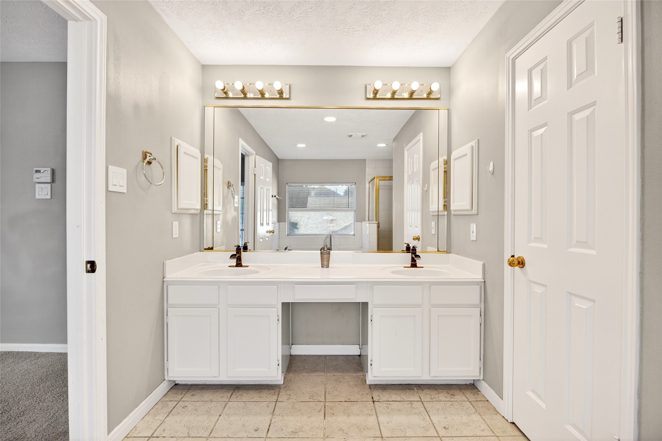 10615 Vandercroft Court Houston, TX 77070 - Photo 30 of 47 a hall with a sink and a mirror
